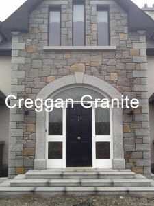 Silver-grey, arched granite door surround